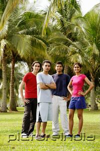PictureIndia - Young adults standing in park, looking at camera