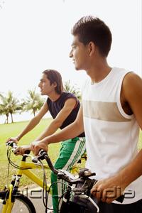 PictureIndia - Two young men on bicycles, sideview
