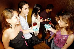 PictureIndia - Young adults standing with drinks, talking