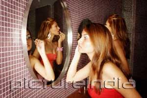 PictureIndia - Two women in public restroom, applying make-up