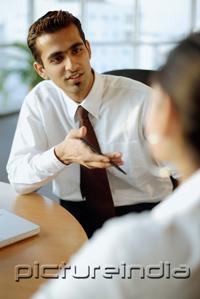 PictureIndia - Male executive having discussion with person in front of him
