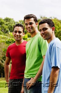 PictureIndia - Young men standing side by side, looking at camera