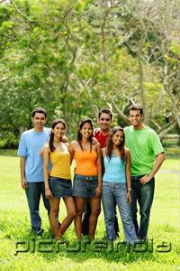 PictureIndia - Group of young adults standing in park, looking at camera