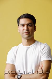 PictureIndia - Man standing, arms crossed, looking at camera