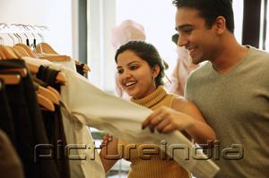 PictureIndia - Couple looking at clothes in shop