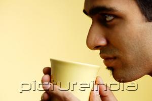 PictureIndia - Man holding mug , profile