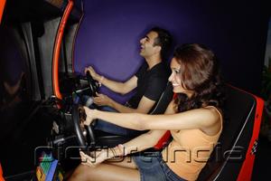 PictureIndia - Couple in a video game arcade, playing games