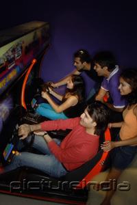 PictureIndia - Young adults in amusement arcade