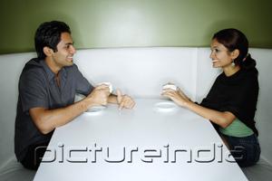 PictureIndia - Couple sitting opposite from each other, having tea