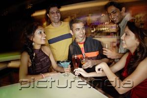 PictureIndia - Young adults having drinks in club