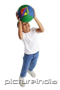 PictureIndia - Boy holding basketball, looking up