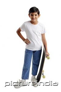 PictureIndia - Boy standing, holding skateboard, hand on hip