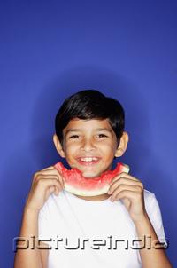 PictureIndia - Boy holding slice of watermelon