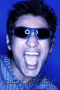 PictureIndia - Man wearing sunglasses, shouting, tinted image