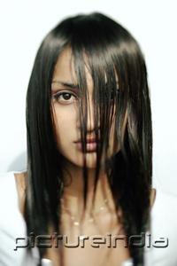 PictureIndia - Young woman with long wet hair covering her face