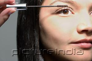 PictureIndia - Woman applying mascara