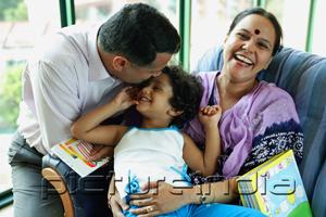 PictureIndia - Family with one child, father kissing daughter's head, mother smiling at camera