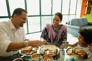 PictureIndia - Family of three having a meal at home