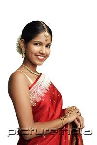 PictureIndia - Woman in traditional Indian costume standing against white background