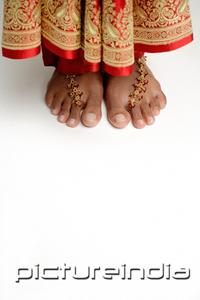 PictureIndia - Woman's feet standing on white floor