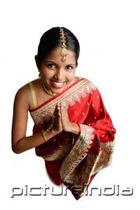 PictureIndia - Woman in sari, standing with hands together, high angle view
