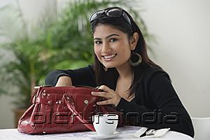 PictureIndia - Woman in cafe, looking in bag