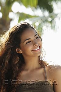 PictureIndia - head shot of young woman smiling and looking off