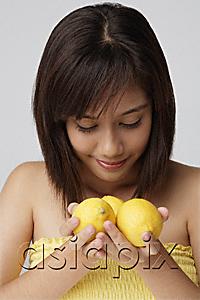 AsiaPix - Young woman smelling lemons