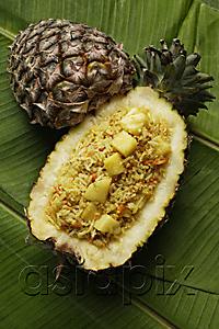 AsiaPix - pineapple rice in fruit shell on banana leaf
