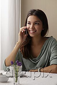 AsiaPix - young woman talking on phone at cafe