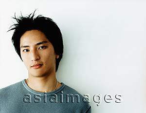 Asia Images Group - Young man against white background, portrait.