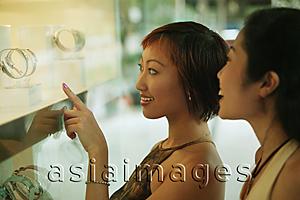 Asia Images Group - Two women in front of shop window,