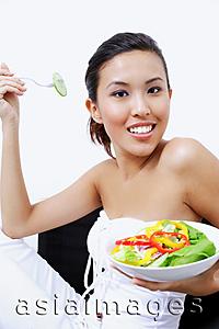 Asia Images Group - Woman holding bowl of salad, smiling at camera