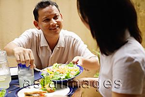 Asia Images Group - Husband serving wife salad