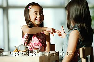 Asia Images Group - Two girls at tea party, playing