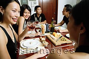 Asia Images Group - Adults having dinner party, over the shoulder view