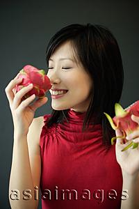 Asia Images Group - Woman smelling dragon fruit
