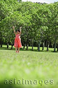 Asia Images Group - Girl walking in park, arms outstretched, smiling