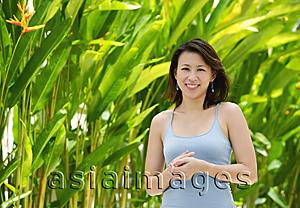 Asia Images Group - Woman standing outdoors, smiling at camera