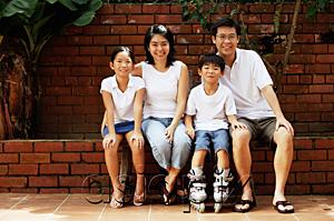 AsiaPix - Family with two children, sitting, looking at camera