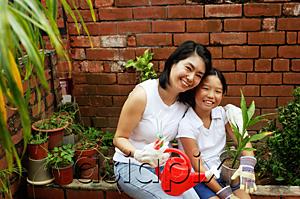 AsiaPix - Mother and daughter, sitting in garden, looking at camera