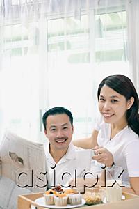 AsiaPix - Couple in bedroom, breakfast tray on bed, looking at camera