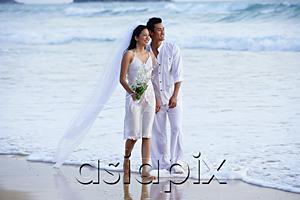 AsiaPix - Bride and groom walking on beach