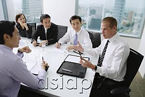 AsiaPix - Executives having a discussion around conference table, Caucasian man at the head of the table
