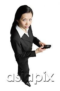 AsiaPix - Businesswoman holding mobile phone, looking at camera