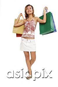 AsiaPix - Young woman carrying shopping bags, looking away