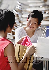 AsiaPix - Two women at cafe, with shopping bags