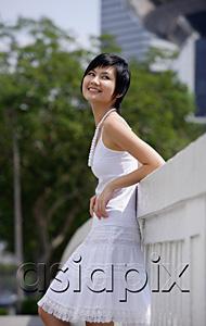 AsiaPix - Woman dressed in white, leaning on bridge