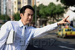 AsiaPix - Businessman with newspaper under his arm, flagging a cab