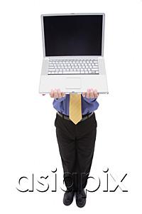AsiaPix - Businessman holding laptop over his face